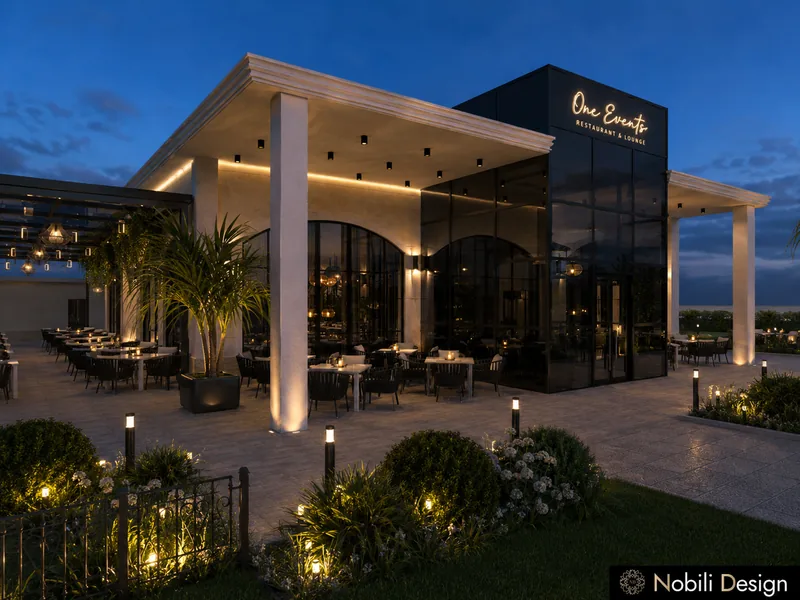 Event venue exterior design with a columned porch, terrace tables and palms in planters at night