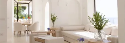 PAOLINO pouf and tray, ANACAPRI dining chair, FABRIZIO dining table, FARAGLIONI sofa